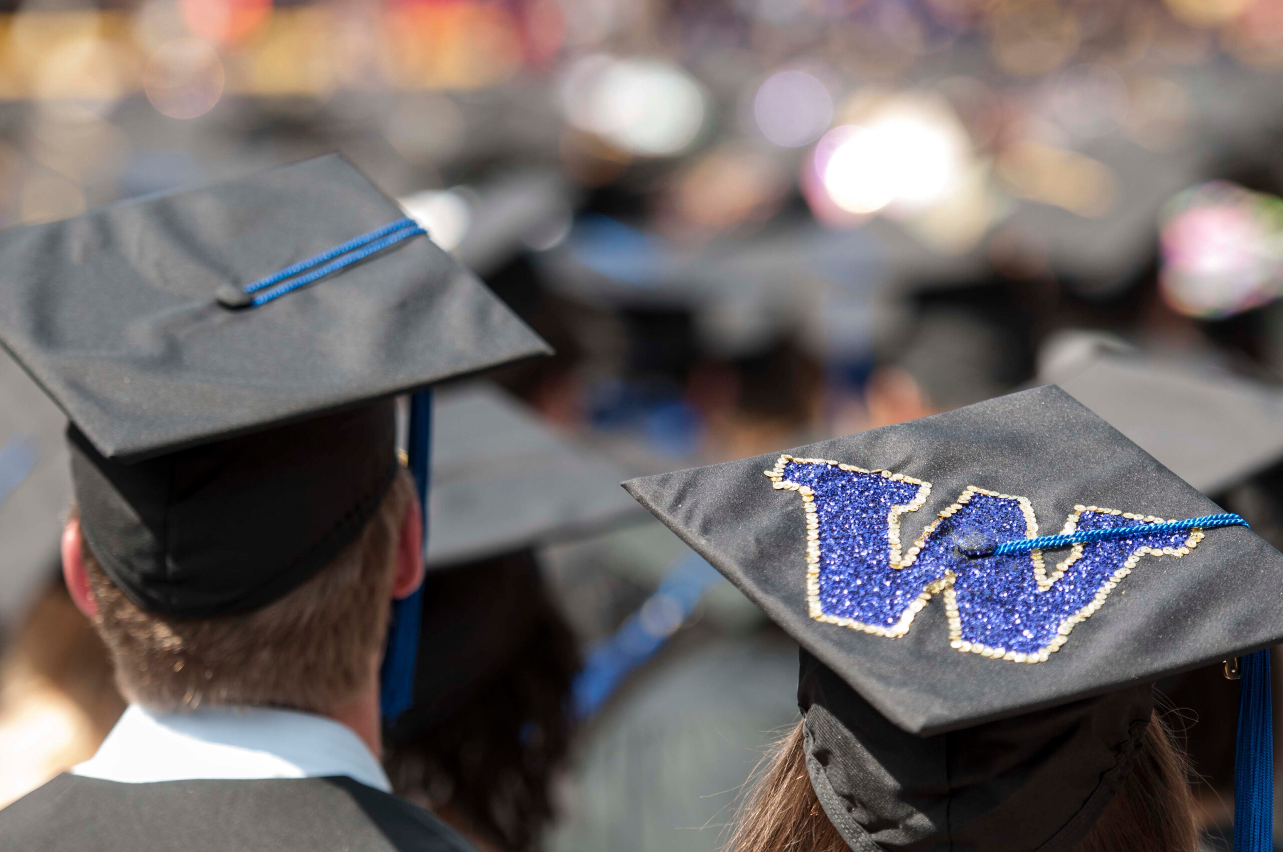 Graduation caps with a purple UW monogram