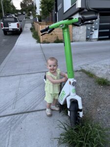 baby holding scooter